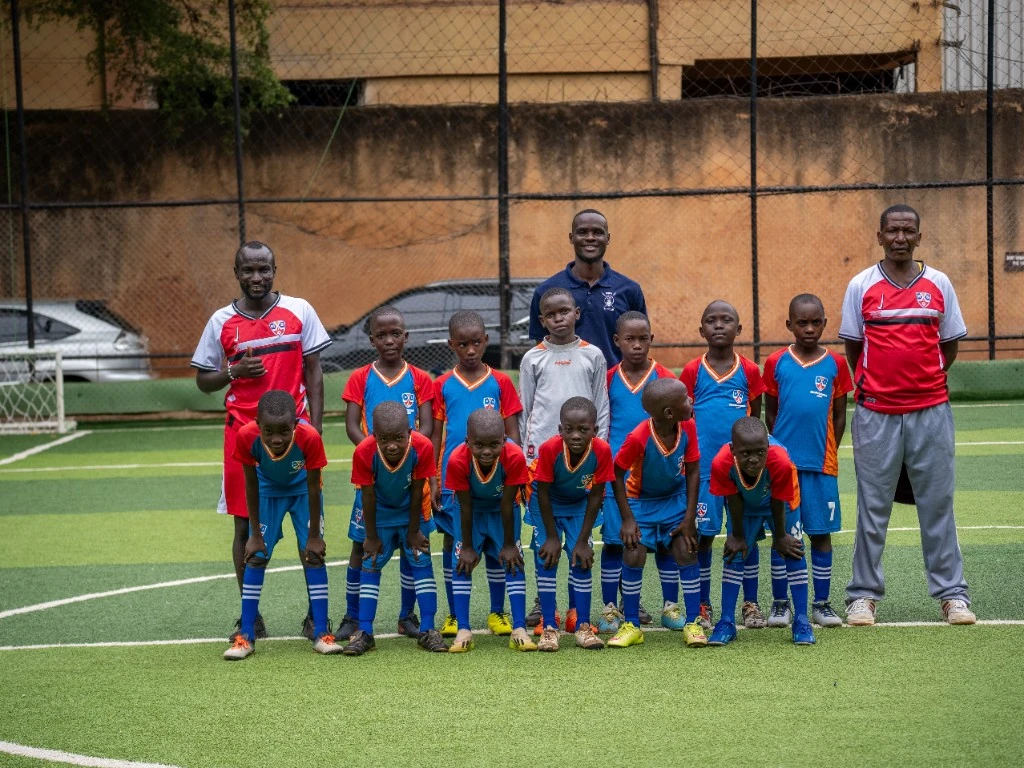 Mentor Sports team photo in blue kits with coaches