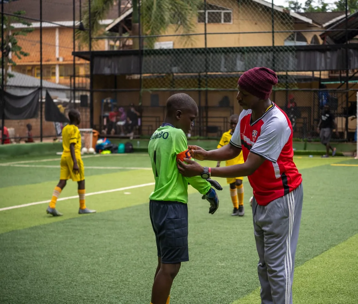 Coach fitting captain's armband on goalkeeper