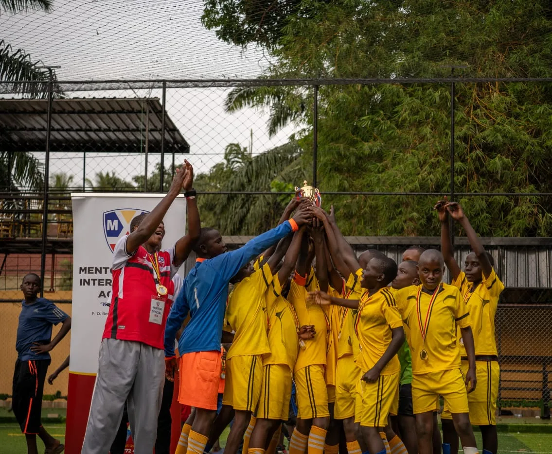 Team lifting trophy together in celebration