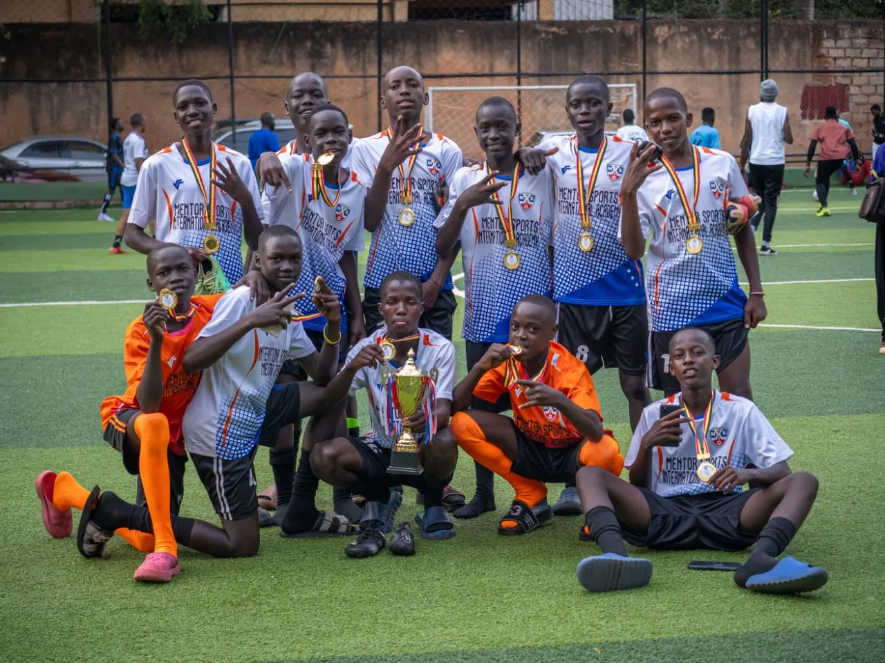 Academy squad posing with trophy and medals